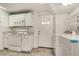 White kitchen features granite countertops, modern appliances, and washer/dryer at 3990 Admiral Dr, Chamblee, GA 30341
