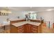 Kitchen with granite countertops, wood cabinets, and view of the living area at 3990 Admiral Dr, Chamblee, GA 30341