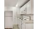 Bright kitchen featuring white cabinets, modern appliances, and sleek countertops at 3990 Admiral Dr, Chamblee, GA 30341