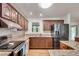 Well-lit kitchen features stainless steel appliances, wood cabinets, and granite countertops at 3990 Admiral Dr, Chamblee, GA 30341
