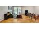 Living room with hardwood floors, large window, sofa and occasional chairs, with stairway in view at 3990 Admiral Dr, Chamblee, GA 30341