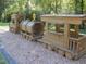 Wooden train play structure at Huntley Hills Park at 3990 Admiral Dr, Chamblee, GA 30341