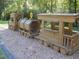A whimsical wooden train play structure in the Huntley Hills Park at 3990 Admiral Dr, Chamblee, GA 30341