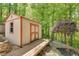 Backyard shed with a wooden deck entrance surrounded by lush greenery at 3990 Admiral Dr, Chamblee, GA 30341