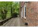 Wooden back deck with railing along a red brick house overlooking lush greenery at 4223 Wieuca Overlook Ne, Atlanta, GA 30342