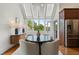 Charming breakfast nook filled with sunlight, adjacent to the kitchen and featuring a stylish round table at 4223 Wieuca Overlook Ne, Atlanta, GA 30342