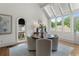 Bright breakfast nook featuring hardwood floors, large windows, and a modern round table with four upholstered chairs at 4223 Wieuca Overlook Ne, Atlanta, GA 30342