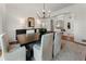 A cozy dining room features wainscoting and white chairs around a dark wooden table at 4223 Wieuca Overlook Ne, Atlanta, GA 30342