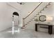 Bright and spacious foyer with marble floors, a staircase with wooden banister, and elegant console table at 4223 Wieuca Overlook Ne, Atlanta, GA 30342