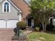 Beautiful front entrance with brick facade, arched doorway, manicured shrubs, and brick paver driveway at 4223 Wieuca Overlook Ne, Atlanta, GA 30342