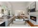 Sun-filled living room with fireplace, backyard views and ample seating at 4223 Wieuca Overlook Ne, Atlanta, GA 30342