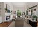 Bright living room with fireplace, built-in shelving, and doors opening to private outdoor area at 4223 Wieuca Overlook Ne, Atlanta, GA 30342