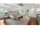 Spacious main bedroom with a tray ceiling, hardwood floors, and a sitting area, next to the ensuite bathroom at 4223 Wieuca Overlook Ne, Atlanta, GA 30342