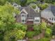 Rear view of a two-story red brick home with lush landscaping and a private backyard at 4223 Wieuca Overlook Ne, Atlanta, GA 30342