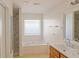 Well-lit bathroom with a tub and a combined shower and bathtub at 6980 Talkeetna Sw Ct, Atlanta, GA 30331