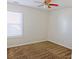 Simple bedroom with carpet, natural light from a window, and a ceiling fan creating a peaceful atmosphere at 6980 Talkeetna Sw Ct, Atlanta, GA 30331