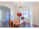 Traditional dining room with hardwood floors, chandelier, and a bay window that provides natural light at 6980 Talkeetna Sw Ct, Atlanta, GA 30331