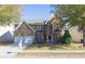 Traditional two-story brick home featuring an attached two-car garage, landscaped yard and mature trees at 6980 Talkeetna Sw Ct, Atlanta, GA 30331