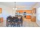 Open kitchen and dining area with tile floors, stainless steel appliances, and wooden cabinetry at 6980 Talkeetna Sw Ct, Atlanta, GA 30331