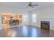 Open-concept living room and kitchen area features hardwood floors, a fireplace and stainless steel appliances at 6980 Talkeetna Sw Ct, Atlanta, GA 30331