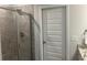 Bathroom with tiled shower and a view of a door that leads to walk-in closet at 82 Hinton Farm Way, Dacula, GA 30019