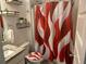 Bright bathroom with a patterned shower curtain, granite countertop sink, and stylish decor at 82 Hinton Farm Way, Dacula, GA 30019