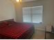 Bedroom with window, ceiling fan, and red and black plaid comforter at 82 Hinton Farm Way, Dacula, GA 30019
