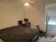 Comfortable bedroom featuring a ceiling fan, natural light, and ample space for a bed and exercise equipment at 82 Hinton Farm Way, Dacula, GA 30019
