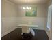 Bright dining room featuring modern lighting, wainscoting, and sleek table setup at 82 Hinton Farm Way, Dacula, GA 30019