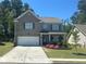 Charming two-story home with a well-manicured lawn and a classic brick facade and a concrete driveway at 82 Hinton Farm Way, Dacula, GA 30019