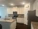 Modern kitchen with stainless steel appliances, granite countertops, and ample cabinet space at 82 Hinton Farm Way, Dacula, GA 30019