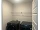 Dark grey Samsung front load washer and dryer in a laundry room at 82 Hinton Farm Way, Dacula, GA 30019