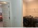 This is a laundry room with a washer and dryer, and view into a bedroom at 82 Hinton Farm Way, Dacula, GA 30019
