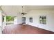 Spacious covered back porch features stained wood floors and a ceiling fan at 9680 Ephesus Church Rd, Villa Rica, GA 30180