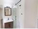 Updated bathroom featuring a glass shower with black fixtures, a dark mirror, and sink at 9680 Ephesus Church Rd, Villa Rica, GA 30180