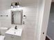 Modern bathroom features shiplap walls, elegant fixtures, and a stylish mirror above the vanity at 9680 Ephesus Church Rd, Villa Rica, GA 30180