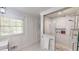 Bright bathroom with a walk-in shower, tile, and storage niche for bath and shower products at 9680 Ephesus Church Rd, Villa Rica, GA 30180