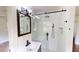 Light bathroom features white tile, shower and modern vanity at 9680 Ephesus Church Rd, Villa Rica, GA 30180