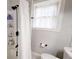 Well-lit bathroom featuring a modern shower stall with built in shelving and a window at 9680 Ephesus Church Rd, Villa Rica, GA 30180