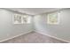 Bright bedroom featuring neutral paint, soft carpet, and windows providing natural light at 9680 Ephesus Church Rd, Villa Rica, GA 30180