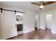 Bedroom featuring a sliding barn door, a walk-in closet, and an attached bathroom at 9680 Ephesus Church Rd, Villa Rica, GA 30180