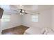 Bedroom with hardwood floors, paneled ceiling, ceiling fan, and natural light from two windows at 9680 Ephesus Church Rd, Villa Rica, GA 30180