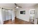 Bedroom with hardwood floors, ceiling fan, TV, and attached bathroom and closet at 9680 Ephesus Church Rd, Villa Rica, GA 30180