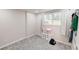 Bright bedroom with carpeted floors, closet space, and natural light streaming through the window at 9680 Ephesus Church Rd, Villa Rica, GA 30180