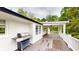 Covered deck with grill, ceiling fan, and views of the green trees at 9680 Ephesus Church Rd, Villa Rica, GA 30180
