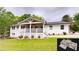 Charming white brick home with a spacious covered porch and manicured lawn at 9680 Ephesus Church Rd, Villa Rica, GA 30180