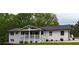 Charming single-story home with white brick, well-manicured lawn, and welcoming porch at 9680 Ephesus Church Rd, Villa Rica, GA 30180