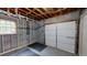 Unfinished garage space with exposed framework and a large door at 9680 Ephesus Church Rd, Villa Rica, GA 30180