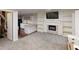 Inviting living room featuring a fireplace, built-in shelves, and a seamless transition to the modern kitchen at 9680 Ephesus Church Rd, Villa Rica, GA 30180