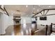 Open living room with hardwood floors, brick fireplace, and exposed beams at 9680 Ephesus Church Rd, Villa Rica, GA 30180